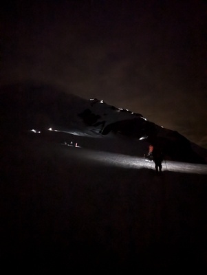 Looking up at climbers with their headlamps heading up the mountain